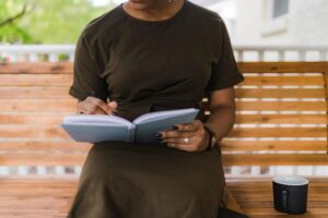 Person writing thoughts in a notebook or journal